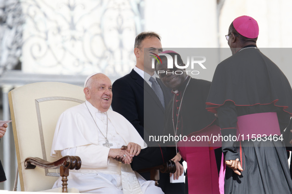 Pope Francis greets bishops and cardinals at the end of his Wednesday general audience in Saint Peter's Square 