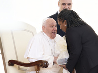 Pope Francis smiles at a pilgrim at the end of his Wednesday general audience in Saint Peter's Square (