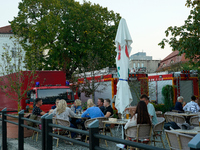 People dining at a restaurant with fire trucks parked nearby are seen in Frankfurt (Oder) on 17 September, 2024. After warnings of increasin...