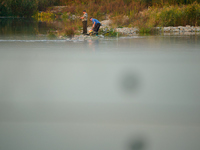 Fishermen are seen on the Polish side of the Oder river in this photo taken in Frankfurt (Oder) on 17 Septembe, 2024. After warnings of incr...