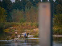 Fishermen are seen on the Polish side of the Oder river in this photo taken in Frankfurt (Oder) on 17 Septembe, 2024. After warnings of incr...