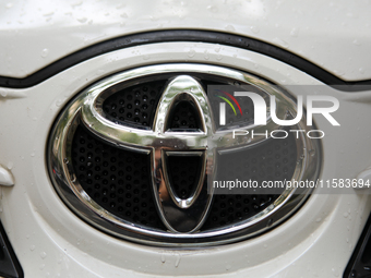 The Toyota logo in the rain is seen on the street in Krakow, Poland, on August 21, 2024. (