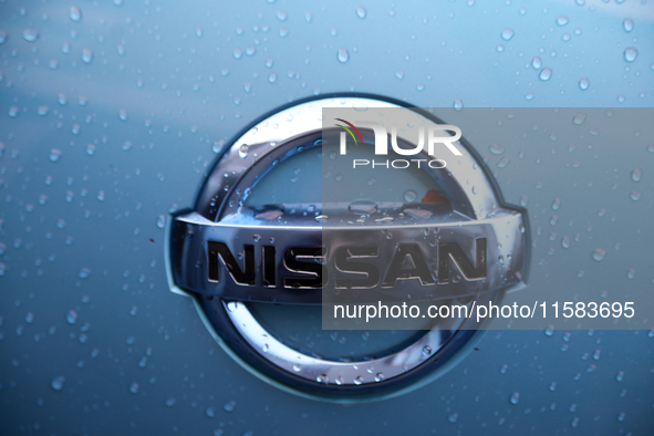 The Nissan logo in the rain is seen on the street in Krakow, Poland, on August 21, 2024. 