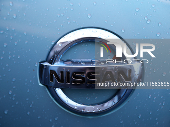 The Nissan logo in the rain is seen on the street in Krakow, Poland, on August 21, 2024. (