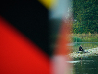 A fisherman is seen on the Polish side of the Oder river in this photo taken in Frankfurt (Oder) on 17 September, 2024. After warnings of in...