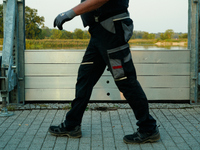 A member of the local fire brigade walks past a newly installed flood barrier in Frankfurt (Oder) on 17 Septembe, 2024. After warnings of in...