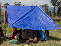 People take shelter in a soccer field after a 5.0 magnitude earthquake strikes in Kertasari, West Java, on September 18, 2024. At least 700...