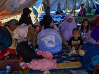 People take shelter in a soccer field after a 5.0 magnitude earthquake strikes in Kertasari, West Java, on September 18, 2024. At least 700...