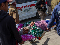 Officers evacuate victims after a 5.0 magnitude earthquake strikes Kertasari, West Java, on September 18, 2024. At least 700 houses are dama...