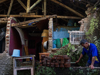 A man stands at his collapsed house after a 5.0 magnitude earthquake strikes in Kertasari, West Java, on September 18, 2024. At least 700 ho...