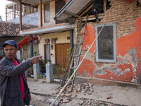 A man looks at his collapsed house after a 5.0 magnitude earthquake strikes in Kertasari, West Java, on September 18, 2024. At least 700 hou...