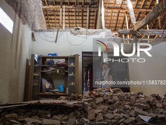 A man looks at his collapsed house after a 5.0 magnitude earthquake strikes in Kertasari, West Java, on September 18, 2024. At least 700 hou...