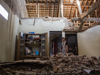 A man looks at his collapsed house after a 5.0 magnitude earthquake strikes in Kertasari, West Java, on September 18, 2024. At least 700 hou...