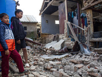 A child looks at his collapsed house after a 5.0 magnitude earthquake strikes in Kertasari, West Java, on September 18, 2024. At least 700 h...