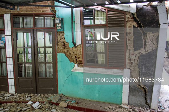 The ruins of a house collapse after a 5.0 magnitude earthquake strikes in Kertasari, West Java, on September 18, 2024. At least 700 houses a...