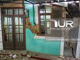 The ruins of a house collapse after a 5.0 magnitude earthquake strikes in Kertasari, West Java, on September 18, 2024. At least 700 houses a...