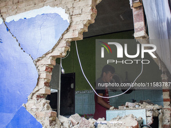 A man looks at his collapsed house after a 5.0 magnitude earthquake strikes in Kertasari, West Java, on September 18, 2024. At least 700 hou...