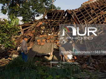 A man looks at his collapsed house after a 5.0 magnitude earthquake strikes in Kertasari, West Java, on September 18, 2024. At least 700 hou...