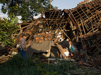 A man looks at his collapsed house after a 5.0 magnitude earthquake strikes in Kertasari, West Java, on September 18, 2024. At least 700 hou...