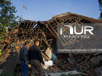 A man looks at his collapsed house after a 5.0 magnitude earthquake strikes in Kertasari, West Java, on September 18, 2024. At least 700 hou...