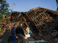 A man looks at his collapsed house after a 5.0 magnitude earthquake strikes in Kertasari, West Java, on September 18, 2024. At least 700 hou...