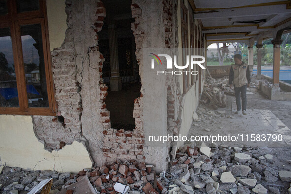 A man looks at a collapsed mosque after a 5.0 magnitude earthquake strikes in Kertasari, West Java, on September 18, 2024. At least 700 hous...