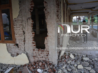 A man looks at a collapsed mosque after a 5.0 magnitude earthquake strikes in Kertasari, West Java, on September 18, 2024. At least 700 hous...