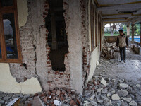 A man looks at a collapsed mosque after a 5.0 magnitude earthquake strikes in Kertasari, West Java, on September 18, 2024. At least 700 hous...