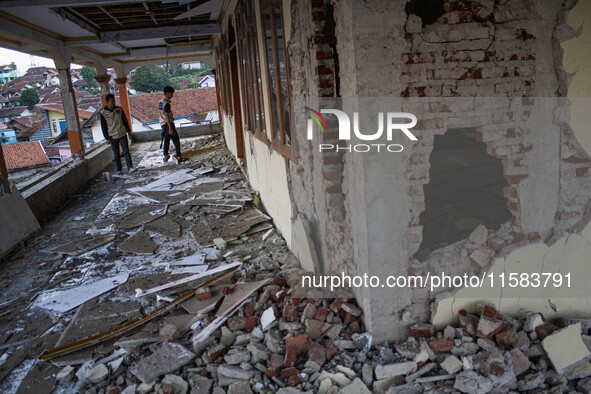 A man looks at a collapsed mosque after a 5.0 magnitude earthquake strikes in Kertasari, West Java, on September 18, 2024. At least 700 hous...