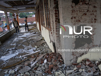 A man looks at a collapsed mosque after a 5.0 magnitude earthquake strikes in Kertasari, West Java, on September 18, 2024. At least 700 hous...