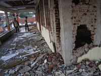 A man looks at a collapsed mosque after a 5.0 magnitude earthquake strikes in Kertasari, West Java, on September 18, 2024. At least 700 hous...