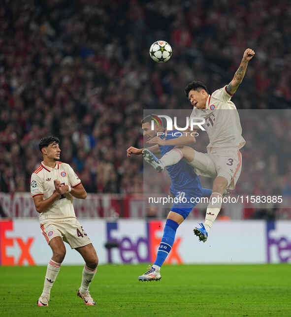 Minjae Kim of Bayern Munich and Marko Pjaca of GNK Dinamo battle for the ball  during the Champions League Round 1 match between Bayern Muni...