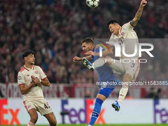 Minjae Kim of Bayern Munich and Marko Pjaca of GNK Dinamo battle for the ball  during the Champions League Round 1 match between Bayern Muni...