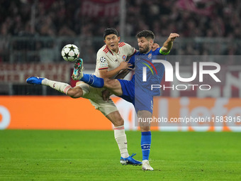 Minjae Kim of Bayern Munich and Bruno Petković of GNK Dinamo battle for the ball  during the Champions League Round 1 match between Bayern M...