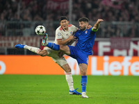 Minjae Kim of Bayern Munich and Bruno Petković of GNK Dinamo battle for the ball  during the Champions League Round 1 match between Bayern M...