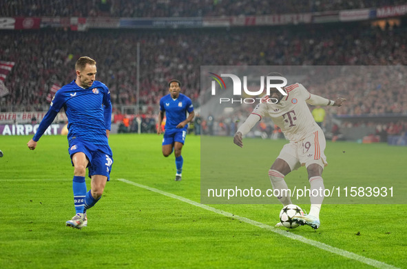 Alphonso Davies of Bayern Munich  controls the ball  during the Champions League Round 1 match between Bayern Munich v Dinamo Zagreb, at the...