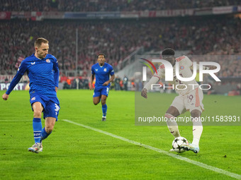 Alphonso Davies of Bayern Munich  controls the ball  during the Champions League Round 1 match between Bayern Munich v Dinamo Zagreb, at the...