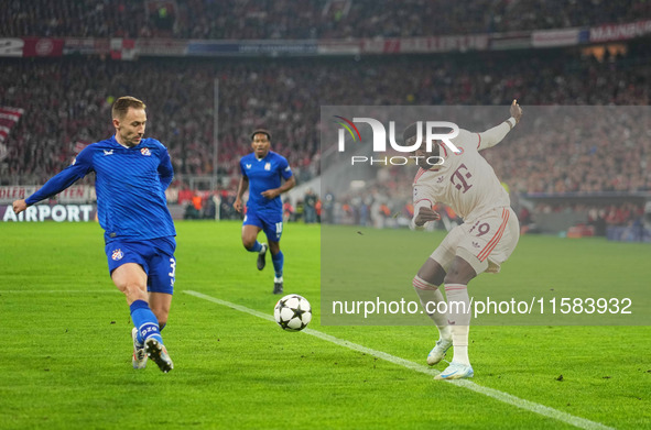 Alphonso Davies of Bayern Munich  controls the ball  during the Champions League Round 1 match between Bayern Munich v Dinamo Zagreb, at the...