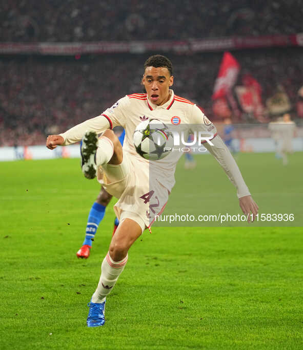 Jamal Musiala of Bayern Munich  controls the ball  during the Champions League Round 1 match between Bayern Munich v Dinamo Zagreb, at the A...