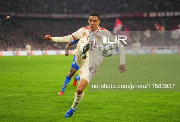 Jamal Musiala of Bayern Munich  controls the ball  during the Champions League Round 1 match between Bayern Munich v Dinamo Zagreb, at the A...