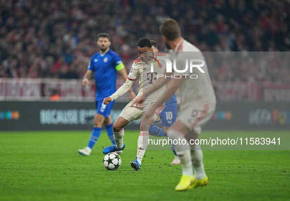 Jamal Musiala of Bayern Munich  controls the ball  during the Champions League Round 1 match between Bayern Munich v Dinamo Zagreb, at the A...