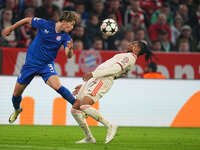 Michael Olise of Bayern Munich and Takuya Ogiwara of GNK Dinamo battle for the ball  during the Champions League Round 1 match between Bayer...