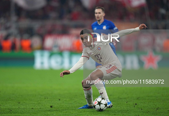 Jamal Musiala of Bayern Munich  controls the ball  during the Champions League Round 1 match between Bayern Munich v Dinamo Zagreb, at the A...