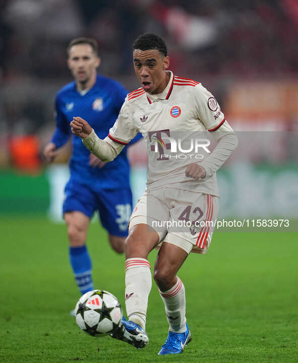 Jamal Musiala of Bayern Munich  controls the ball  during the Champions League Round 1 match between Bayern Munich v Dinamo Zagreb, at the A...