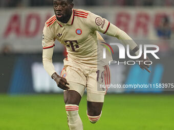 Alphonso Davies of Bayern Munich  controls the ball  during the Champions League Round 1 match between Bayern Munich v Dinamo Zagreb, at the...