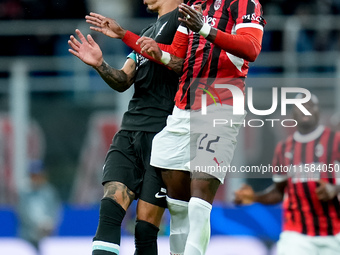 Emerson Royal of AC Milan and Darwin Nunez of Liverpool FC jump for the ball during the UEFA Champions League 2024/25 League Phase MD1 match...