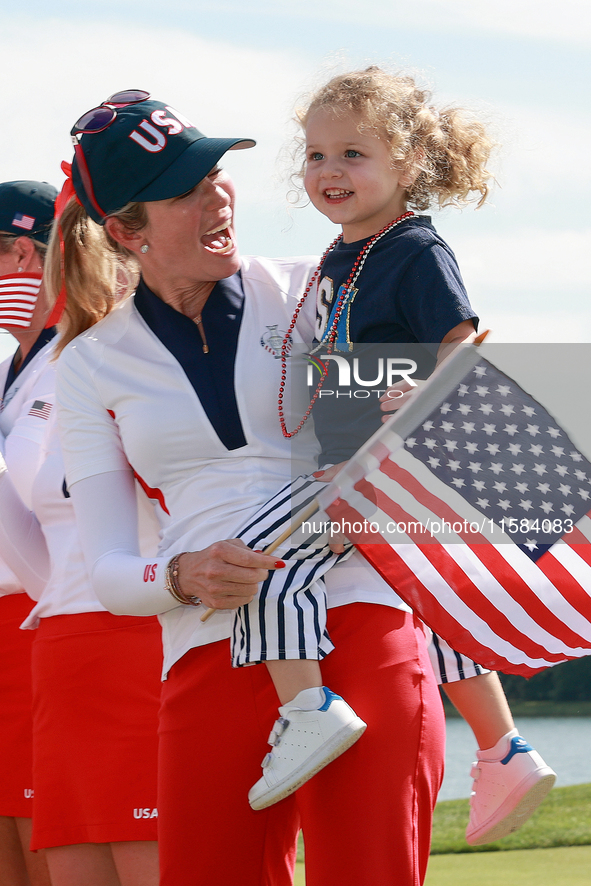 GAINESVILLE, VIRGINIA - SEPTEMBER 15: Vice Captain Paula Creamer of Team USA holds her daughter Hilton on the 18th green at the conclusion o...