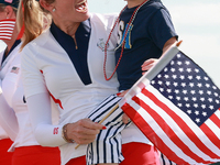 GAINESVILLE, VIRGINIA - SEPTEMBER 15: Vice Captain Paula Creamer of Team USA holds her daughter Hilton on the 18th green at the conclusion o...