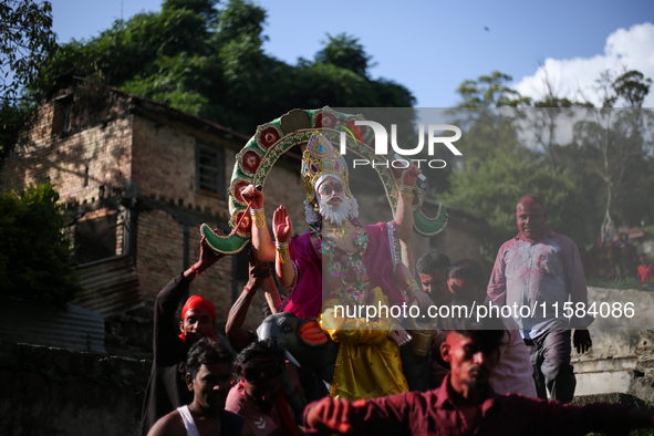 Devotees take the idol of Lord Vishwokarma to immerse it in a river on the outskirts of Kathmandu, Nepal, on September 18, 2024. Vishwokarma...