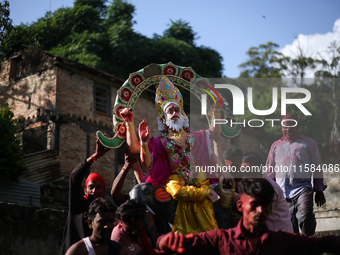 Devotees take the idol of Lord Vishwokarma to immerse it in a river on the outskirts of Kathmandu, Nepal, on September 18, 2024. Vishwokarma...